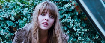 Movie still from “4.3.2.1.” (2010), directed by Mark Davis – A person with long brown hair; Close Up shot, Over the shoulder angle