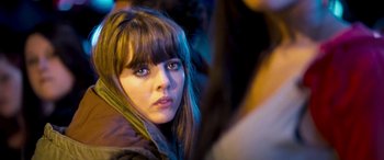 Movie still from “4.3.2.1.” (2010), directed by Mark Davis – A person with long hair; Close Up shot, Over the shoulder angle