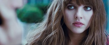 Movie still from “4.3.2.1.” (2010), directed by Mark Davis – A woman's face with long hair; Close Up shot, Low angle