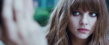 Movie still from “4.3.2.1.” (2010), directed by Mark Davis – A woman's eyes and hair; Close Up shot, Over the shoulder angle