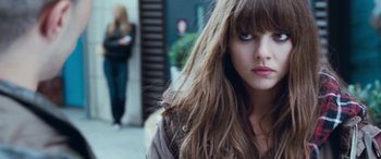 Movie still from “4.3.2.1.” (2010), directed by Mark Davis – A person with long brown hair; Close Up shot, Over the shoulder angle