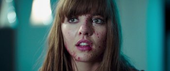 Movie still from “4.3.2.1.” (2010), directed by Mark Davis – A person with blood all over her face; Close Up shot, Low angle