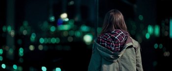 Movie still from “4.3.2.1.” (2010), directed by Mark Davis – A woman standing in front of a street light; Medium shot, Over the shoulder angle