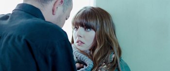 Movie still from “4.3.2.1.” (2010), directed by Mark Davis – A man and a woman looking at one another; Close Up shot, Over the shoulder angle