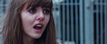 Movie still from “4.3.2.1.” (2010), directed by Mark Davis – A woman's face with her mouth wide open; Close Up shot, Over the shoulder angle