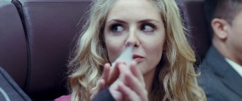 Movie still from “4.3.2.1.” (2010), directed by Mark Davis – A person holding something in her mouth; Close Up shot, Over the shoulder angle