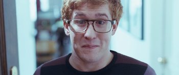 Movie still from “4.3.2.1.” (2010), directed by Mark Davis – A person wearing glasses; Close Up shot, Low angle