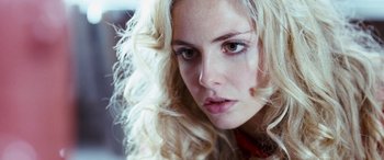 Movie still from “4.3.2.1.” (2010), directed by Mark Davis – A woman with blonde hair; Close Up shot, Low angle