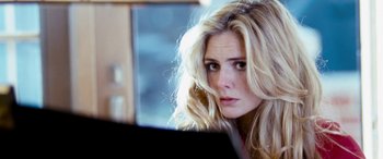 Movie still from “4.3.2.1.” (2010), directed by Mark Davis – A woman with blonde hair is looking at a computer screen; Close Up shot, Over the shoulder angle