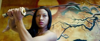 Movie still from “4.3.2.1.” (2010), directed by Mark Davis – A woman holding a sword in front of a painting; Close Up shot, Low angle