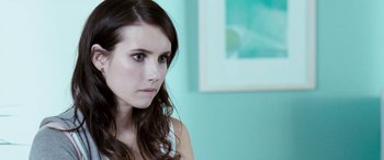 Movie still from “4.3.2.1.” (2010), directed by Mark Davis – A beautiful young woman with long brown hair; Close Up shot, Over the shoulder angle