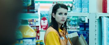 Movie still from “4.3.2.1.” (2010), directed by Mark Davis – A woman standing in front of a shelf in a store; Close Up shot, Over the shoulder angle