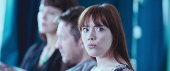 Movie still from “4.3.2.1.” (2010), directed by Mark Davis – A person sitting in front of another person; Close Up shot, Over the shoulder angle