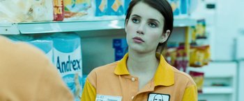 Movie still from “4.3.2.1.” (2010), directed by Mark Davis – A woman in an orange and yellow uniform; Close Up shot, Over the shoulder angle