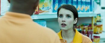 Movie still from “4.3.2.1.” (2010), directed by Mark Davis – A woman in an orange and yellow shirt talking to a man; Close Up shot, Over the shoulder angle