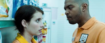 Movie still from “4.3.2.1.” (2010), directed by Mark Davis – A man and a woman looking at each other; Close Up shot, Over the shoulder angle