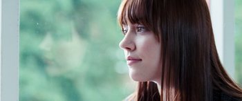 Movie still from “4.3.2.1.” (2010), directed by Mark Davis – A person with long hair and blue eyes; Close Up shot, Over the shoulder angle