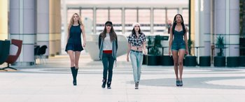 Movie still from “4.3.2.1.” (2010), directed by Mark Davis – A group of women walking down a sidewalk; Wide shot, Low angle