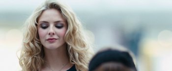 Movie still from “4.3.2.1.” (2010), directed by Mark Davis – A person with long blonde hair; Close Up shot, Over the shoulder angle