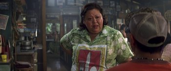 Movie still from “50 First Dates” (2004), directed by Peter Segal – An older woman wearing a green shirt with a knife on it; Close Up shot, Over the shoulder angle