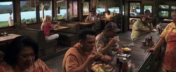 Movie still from “50 First Dates” (2004), directed by Peter Segal – A group of people sitting at a table eating food; Wide shot, High angle