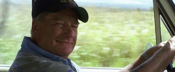 Movie still from “50 First Dates” (2004), directed by Peter Segal – A person wearing a hat near a window; Close Up shot, Over the shoulder angle