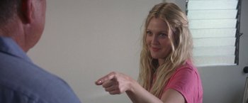 Movie still from “50 First Dates” (2004), directed by Peter Segal – A beautiful blond haired woman in a pink shirt pointing at a camera; Close Up shot, Over the shoulder angle