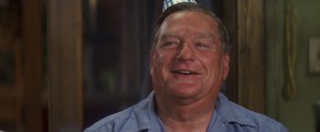Movie still from “50 First Dates” (2004), directed by Peter Segal – An older man wearing a blue shirt and wearing a party hat; Close Up shot, Over the shoulder angle