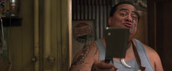 Movie still from “50 First Dates” (2004), directed by Peter Segal – A man holding a meat cleaver in front of a mirror; Close Up shot, Over the shoulder angle