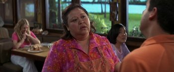 Movie still from “50 First Dates” (2004), directed by Peter Segal – An older woman wearing a pink and orange floral shirt; Close Up shot, Over the shoulder angle
