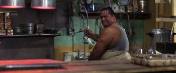 Movie still from “50 First Dates” (2004), directed by Peter Segal – A man is washing his hands in a sink; Medium shot, High angle