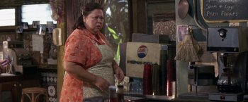 Movie still from “50 First Dates” (2004), directed by Peter Segal – A woman standing in front of a soda machine; Medium shot, Over the shoulder angle