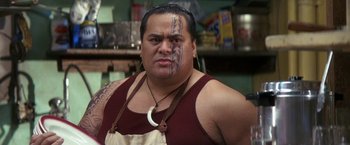 Movie still from “50 First Dates” (2004), directed by Peter Segal – A man with tattoos on his face is wearing an apron; Close Up shot, Low angle