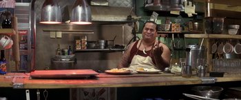 Movie still from “50 First Dates” (2004), directed by Peter Segal – A man sitting at a table in front of a plate of food; Medium shot, Over the shoulder angle