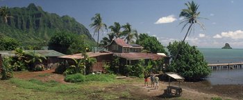 Movie still from “50 First Dates” (2004), directed by Peter Segal – Two people standing in front of a house on a dirt field; Extreme Wide shot, High angle