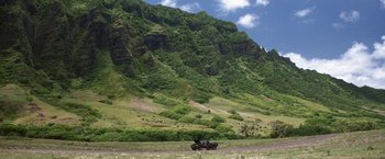 Movie still from “50 First Dates” (2004), directed by Peter Segal – A tractor in the middle of a field with a mountain in the background; Extreme Wide shot, High angle