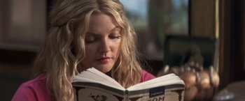 Movie still from “50 First Dates” (2004), directed by Peter Segal – A woman is reading a book in a cafe; Close Up shot, Low angle