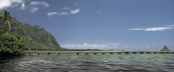 Movie still from “50 First Dates” (2004), directed by Peter Segal – A body of water that has a mountain in the background; Extreme Wide shot, Low angle