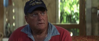 Movie still from “50 First Dates” (2004), directed by Peter Segal – An older man wearing a red shirt and a blue hat; Close Up shot, Over the shoulder angle