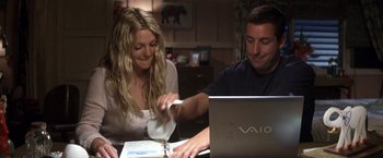 Movie still from “50 First Dates” (2004), directed by Peter Segal – A man and a woman sitting in front of an open laptop computer; Medium shot, High angle