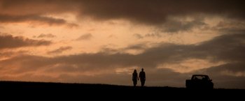 Movie still from “50 First Dates” (2004), directed by Peter Segal – Two people holding hands while standing on top of a hill; Extreme Wide shot, Low angle