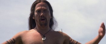 Movie still from “50 First Dates” (2004), directed by Peter Segal – A man with long brown hair and a necklace; Close Up shot, Low angle