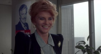 Movie still from “52 Pick-Up” (1986), directed by John Frankenheimer – A woman with blonde hair wearing a black jacket; Close Up shot, Low angle