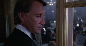 Movie still from “52 Pick-Up” (1986), directed by John Frankenheimer – A person looking out a window; Close Up shot, Over the shoulder angle
