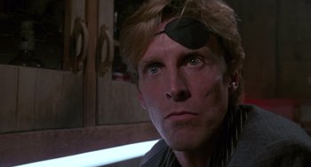 Movie still from “52 Pick-Up” (1986), directed by John Frankenheimer – A person with a patch on their forehead; Close Up shot, Low angle