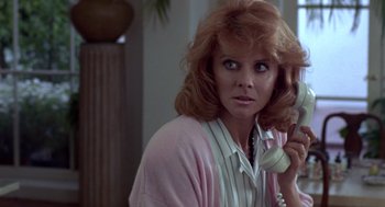 Movie still from “52 Pick-Up” (1986), directed by John Frankenheimer – A person talking on a phone; Close Up shot, Low angle