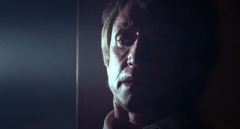 Movie still from “52 Pick-Up” (1986), directed by John Frankenheimer – A person looking at the camera; Close Up shot, Low angle