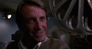 Movie still from “52 Pick-Up” (1986), directed by John Frankenheimer – A person smiling for the camera; Close Up shot, Low angle