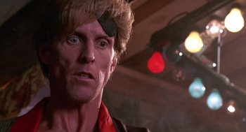 Movie still from “52 Pick-Up” (1986), directed by John Frankenheimer – A person wearing a hat; Close Up shot, Low angle