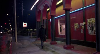 Movie still from “52 Pick-Up” (1986), directed by John Frankenheimer – A man walking down the street at night; Wide shot, Low angle